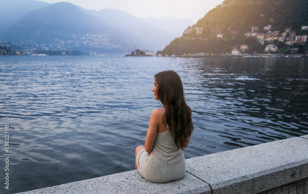 Young woman at the lake Como at sunset