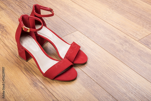 Women's Red Suede Sandals on Wood Flooring