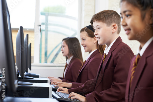 Pupils Wearing School Uniform In Computer Class photo