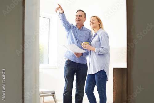 Woman Meeting With Architect Or Builder In Rennovated Property photo