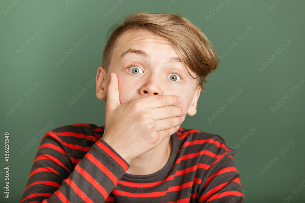 Boy shocked covering his mouth Boy shocked covering his mouth
