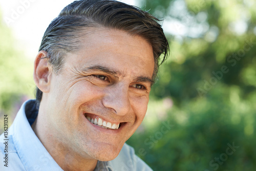 Outdoor Head And Shoulders Portrait Of Smiling Mature Man