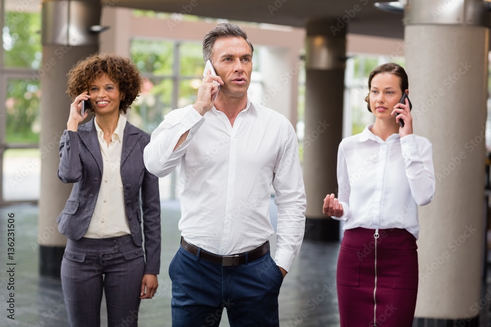 Business executives talking on mobile phone Business executives talking on mobile phone