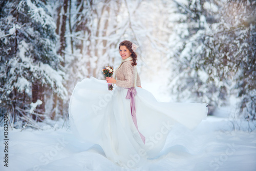 Beautiful bride in snowy winter forest