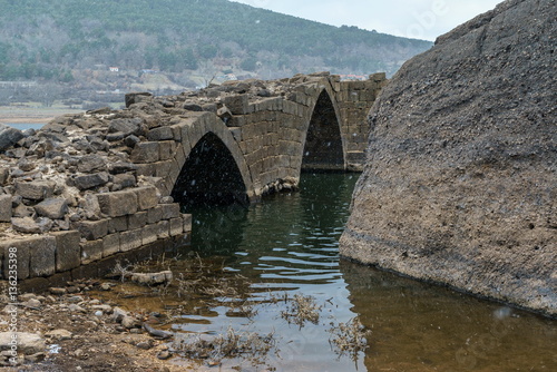 Ancient romanic bridge in a cold day.