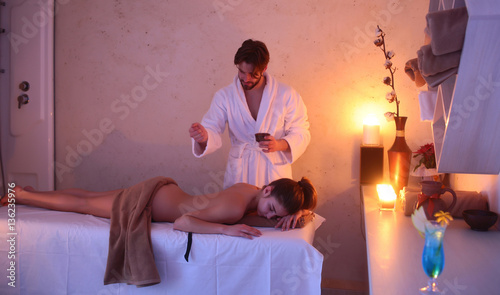 sexy woman on spa salon massage with bearded handsome therapist