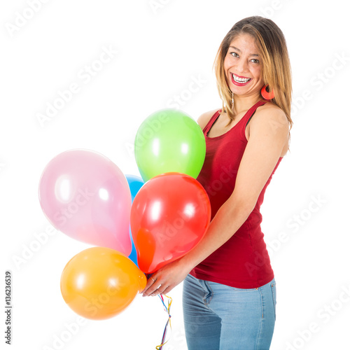 Pretty woman holding colorful balloons isolated on white background