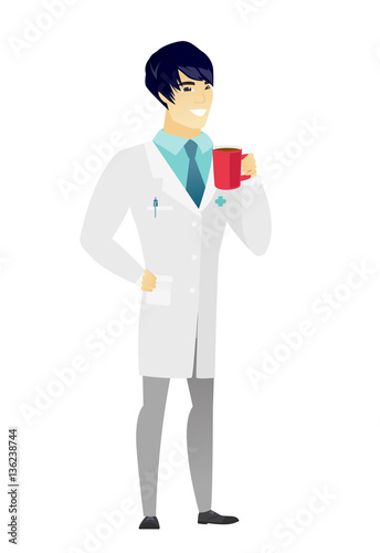 Young asian doctor holding cup of coffee.