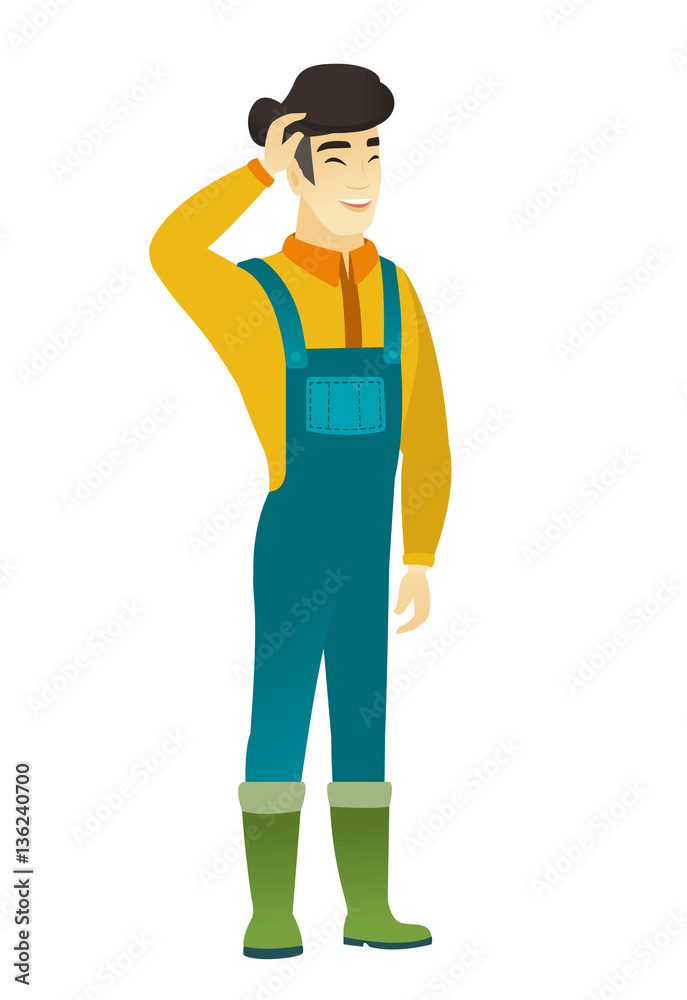 Young asian farmer in coveralls laughing.