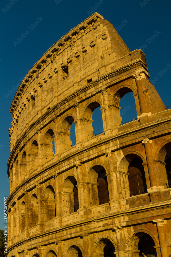 Colosseum or Coliseum Amphitheatre, evening in Rome.