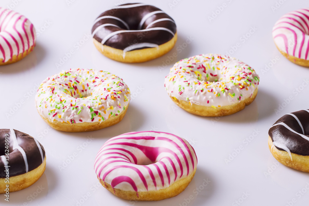 Various colorful donuts on a white background