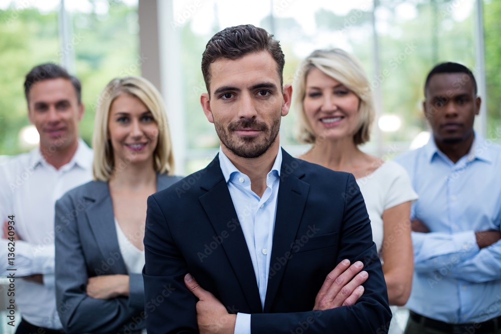 Business executives with arms crossed at conference center Business executives with arms crossed at conference center