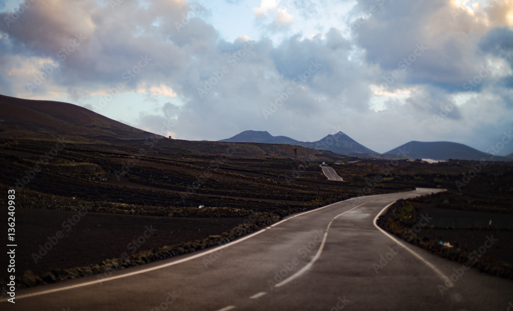 View of Road Along Volcanic Landscape with Mountains
