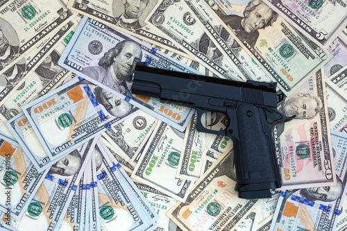 Gun and money background - bussiness concept