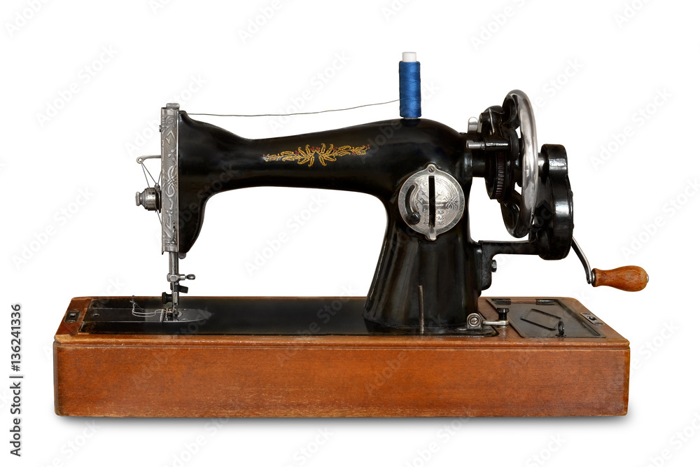 old sewing machine with manual drive on white isolated background