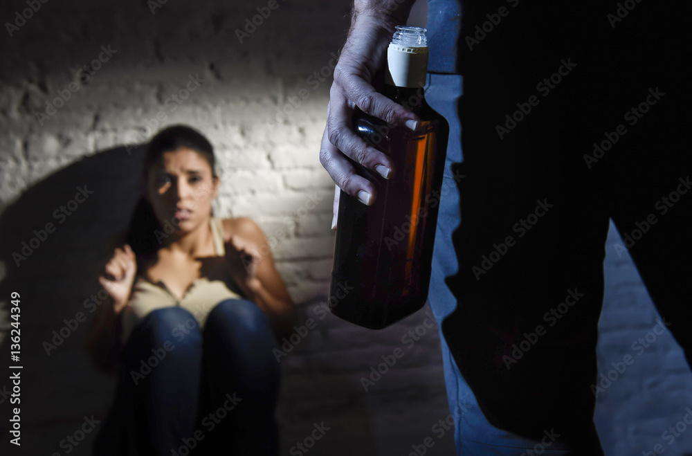 alcoholic drunk man attacking woman or wife with bottle in domestic violence concept alcoholic drunk man attacking woman or wife with bottle in domestic violence concept