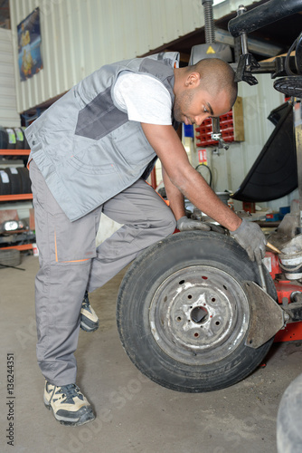 worker fixing a tire