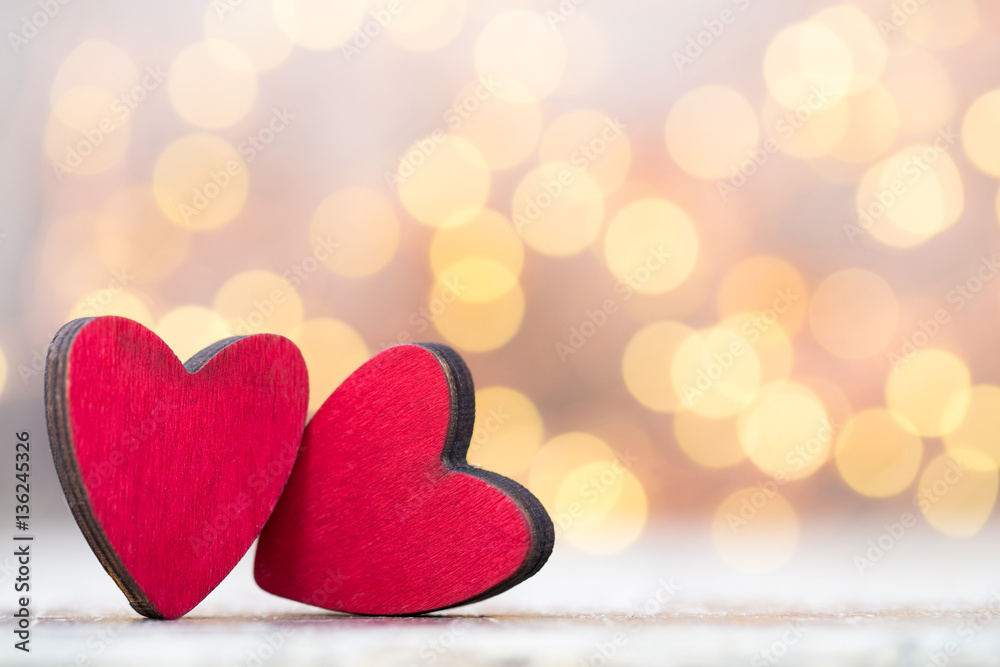 Fototapeta premium Two red hearts the wooden background.