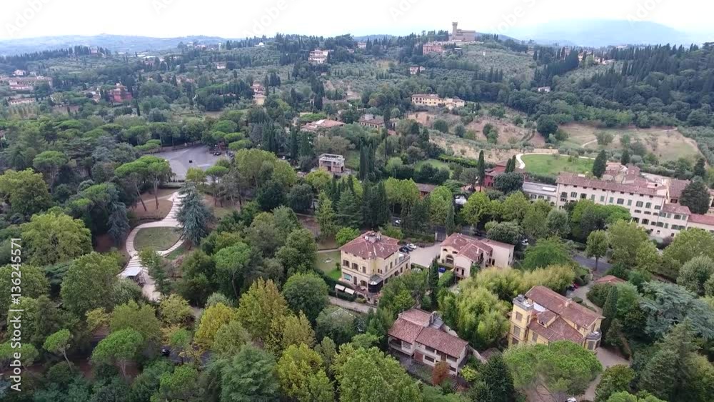 Aerial flight over Italy typical Tuscany landscape flying over several buildings and homes and showing Tuscany hills a traditionally popular tourist destination Italy one of main tourist attraction 4k