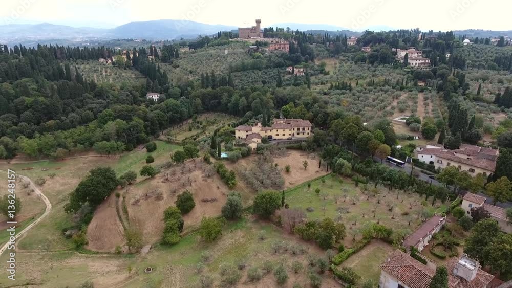 Aerial flight over Italy typical Tuscany landscape flying over luxurious home with swimming pool in background showing Tuscany hills a traditionally popular tourist destination in Italy 4k quality
