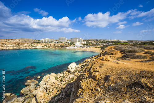 Ghajn Tuffieha, Malta - Panoramic skyline view of Golden Bay, Malta's most beautiful sandy beach on a nice summer day with blue sky and clouds