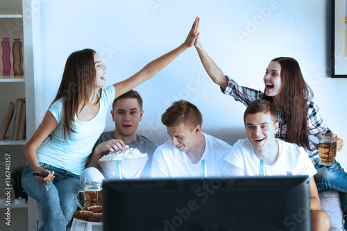 Young fans watching sports ...