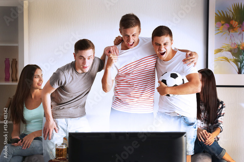 Young fans watching footbal...