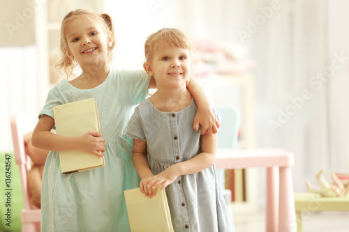 Cute little sisters with bo...