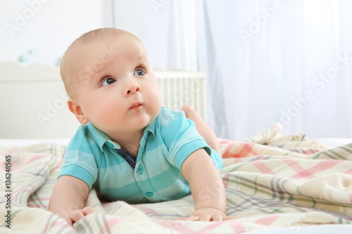 Cute baby lying on bed