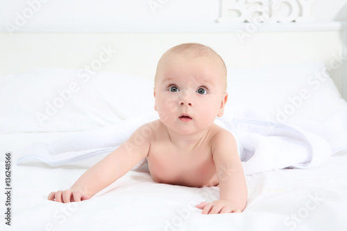 Cute baby lying on bed