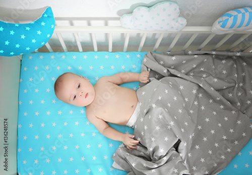 Cute baby lying in bed