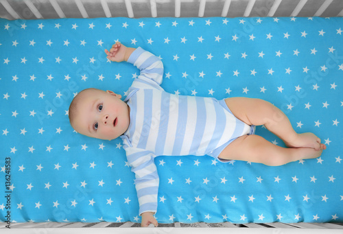 Cute baby lying in bed