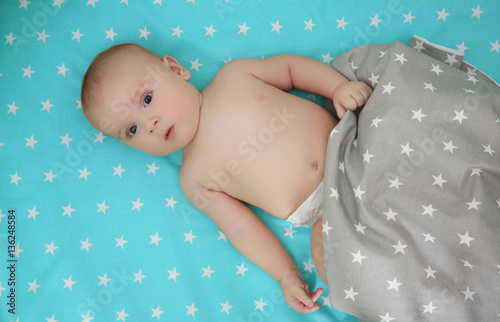 Cute baby lying in bed