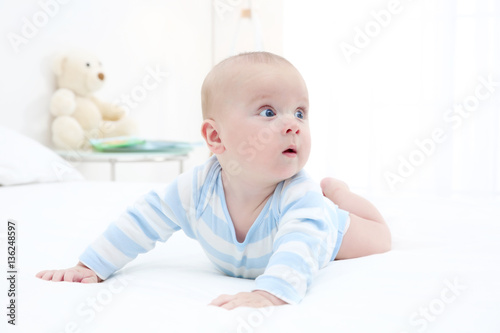 Cute baby lying on bed