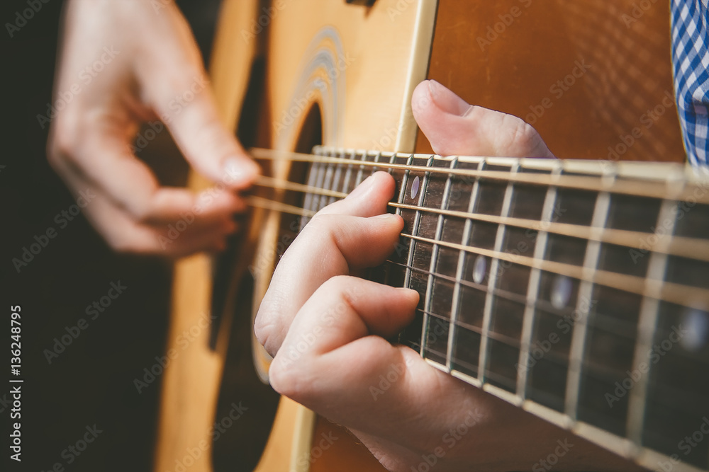 Fototapeta premium Close up of guitarist hand playing guitar