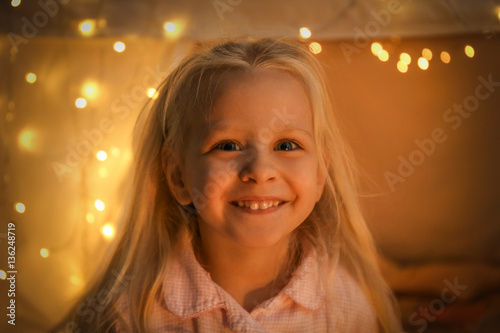 Portrait of cute smiling girl on blurred background