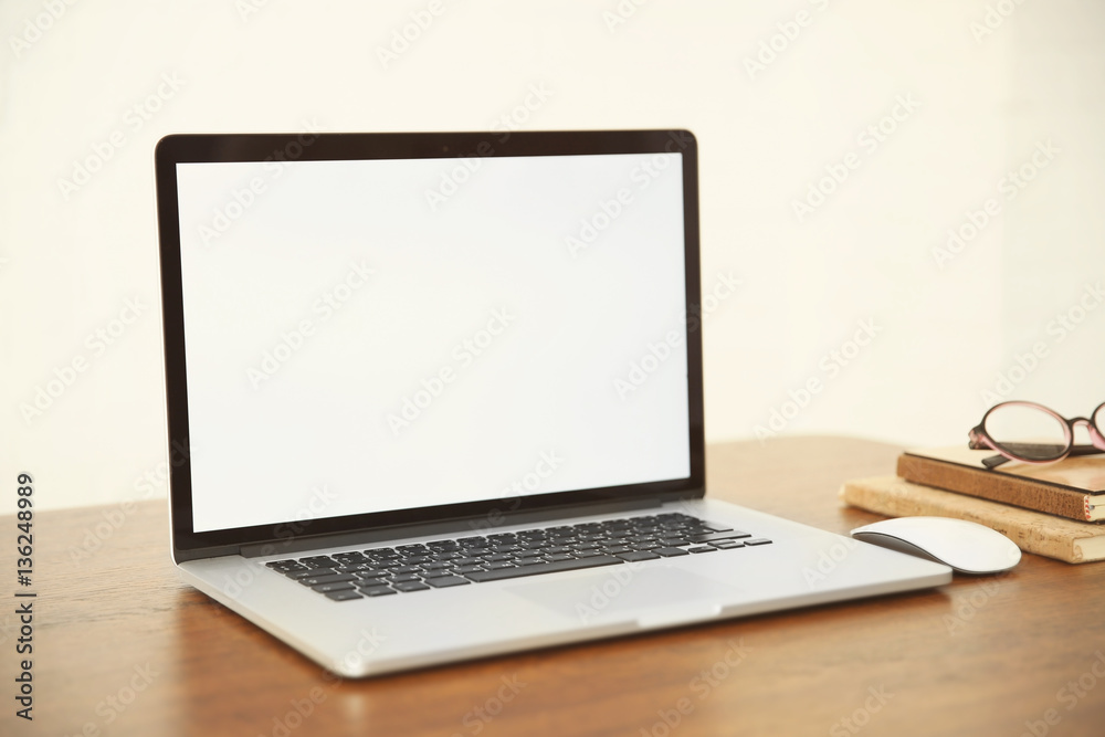Modern laptop on wooden desk Modern laptop on wooden desk