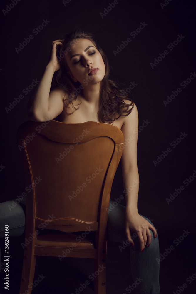 Fototapeta premium Luxurious topless woman with lush hair in the dark room