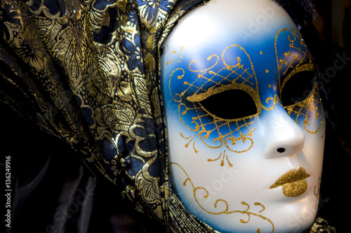 Beautiful white and blue mask on exhibitor. Picture taken in Venice (Italy) during the traditional carnival celebration.