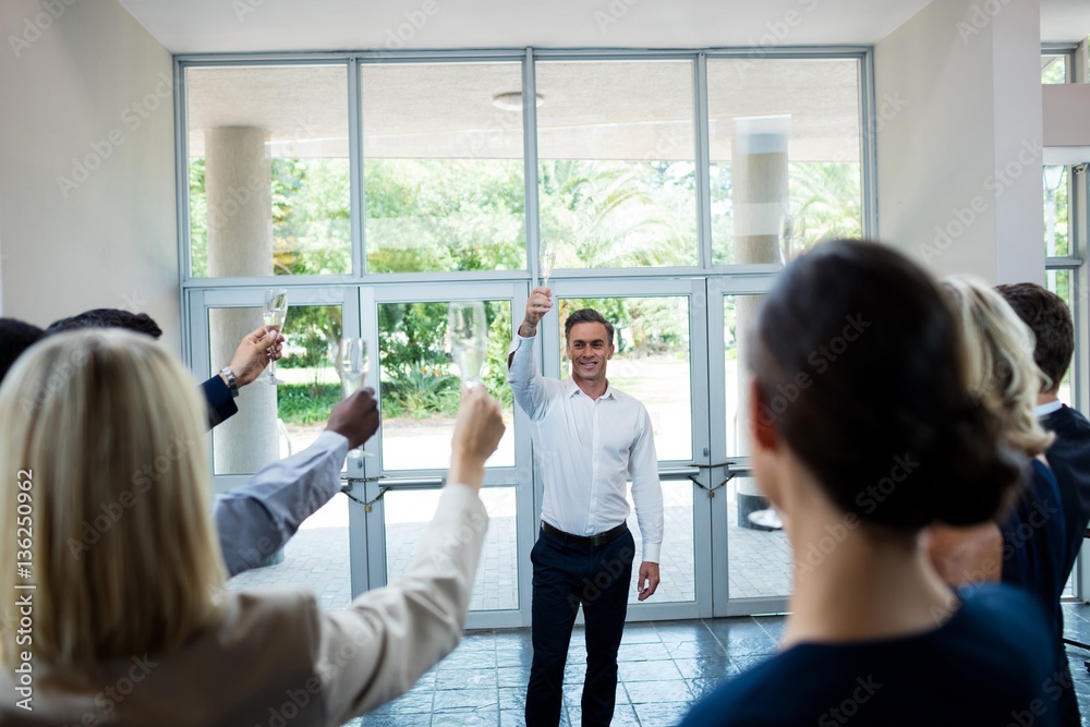 Business executives celebrating at conference center Business executives celebrating at conference center