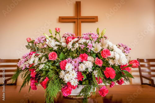 Fotografia, Obraz Christian cross and flowers on altar