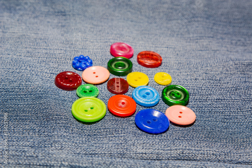 collection of various button of sewing on a jeans lie. a blue jeans and the button for to be sewed