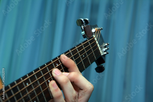 Close up view of guitarist who is playing the guitar.