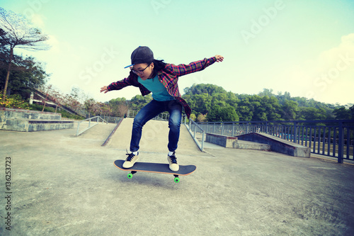 young skateboarder riding skateboard at skatepark