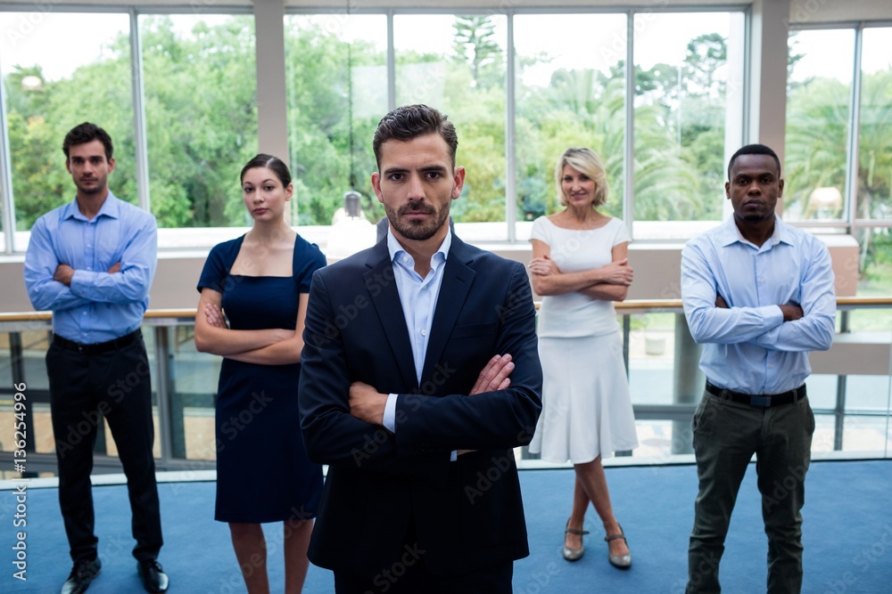Business executives with arms crossed at conference center Business executives with arms crossed at conference center