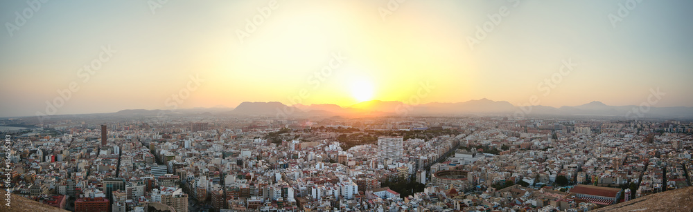 Panoramic view of the old town of Alicante, backlit at sunset from the top of the castle of Santa Barbara
