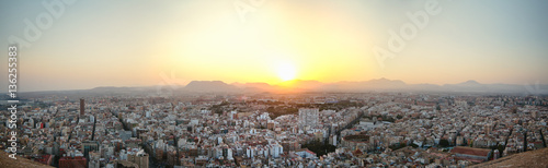 Panoramic view of the old town of Alicante, backlit at sunset from the top of the castle of Santa Barbara