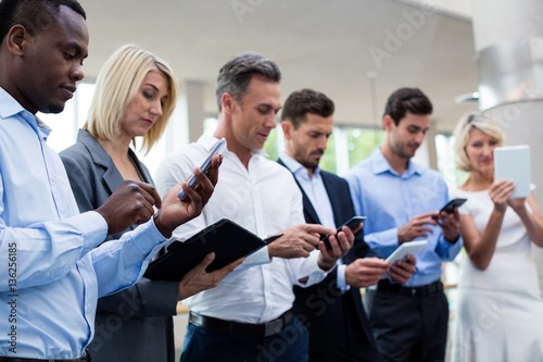 Business executives using digital tablet and mobile phone