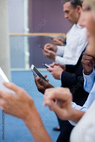 Business executives using digital tablet and mobile phone