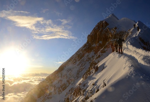Sun rising over the clouds to reveal the Mountains beauty.